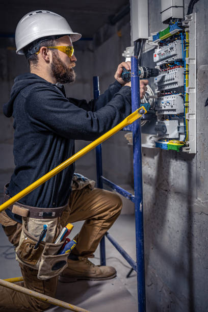 istock A male electrician works in a switchboard with an electrical connecting cable. 1354891384