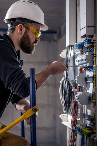 istock A male electrician works in a switchboard with an electrical connecting cable. 1354891512