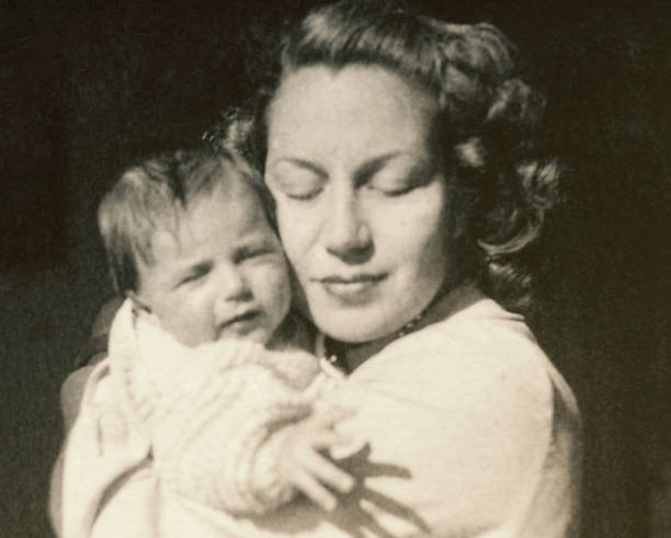 Young mother with her baby in 1948. stock photo