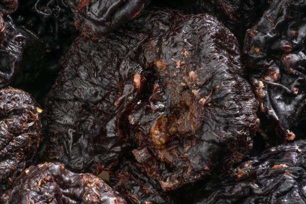 istock close up shot of dried plums. 1354894730
