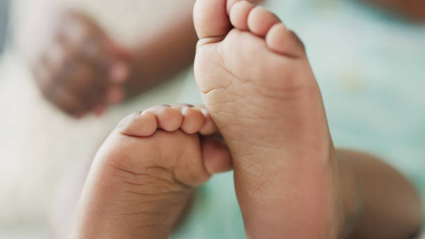 istock Shot of a. unrecognizable babies feet at home 1354894820