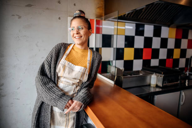 Happy Smiling Fast-Food Worker Standing in a Restaurant