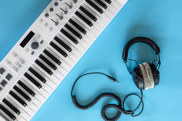 istock Headphones and keys on a blue background, top view. 1354895108