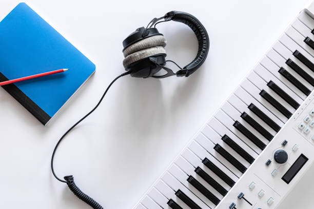 istock Musical flat lay background with headphones musical keys. 1354895166