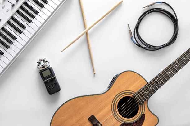 Acoustic guitar on a white background, top view, the concept of musical creativity, hobby.