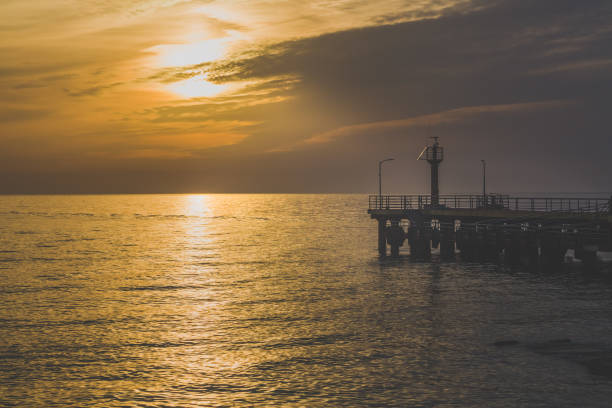 istock view of the sea pier at sunset 1354898371