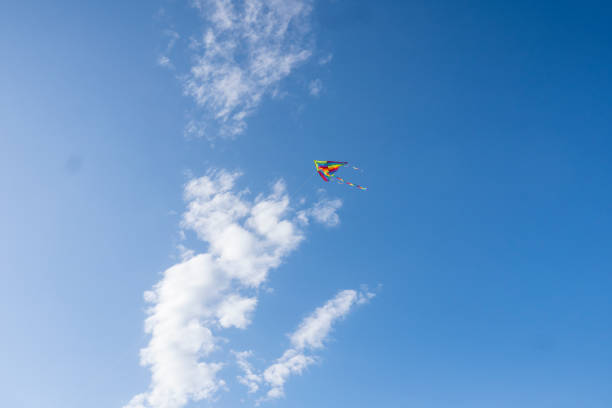 istock Colorful kites flying in the blue sky 1354898498