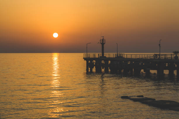 istock view of the sea pier at sunset 1354898564