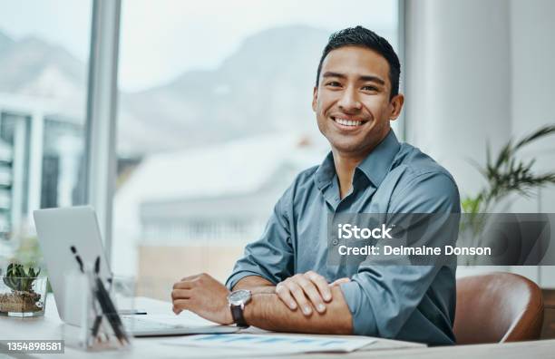 Shot Of A Young Businessman Using A Laptop In A Modern Office Stock Photo - Download Image Now