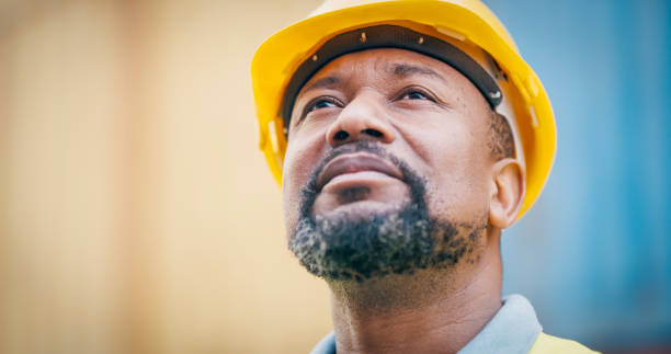 Shot of a mature man wearing a hardhat at work stock photo