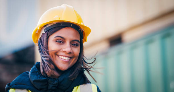 istock Shot of a young woman wearing a hardhat at work 1354899111