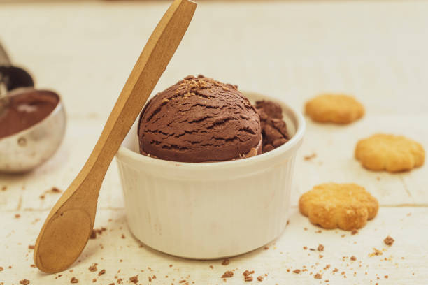 istock Bowl with ice cream on wooden background. 1354900236