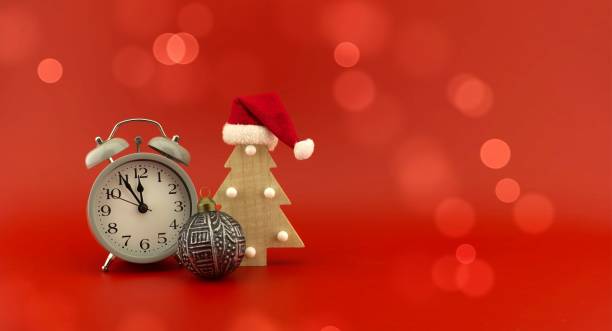 istock Christmas tree with Santa hat and vintage clock 1354900527
