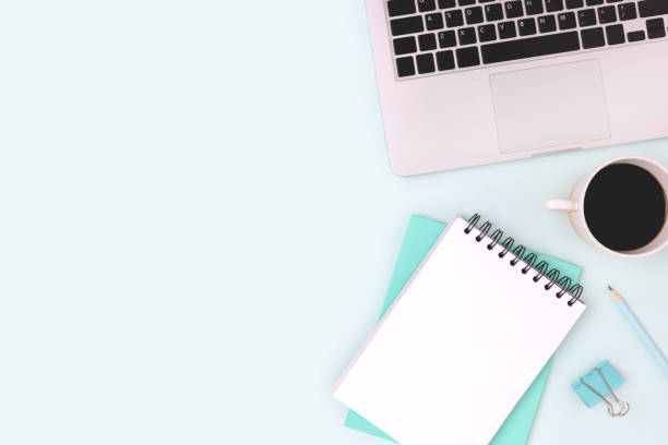 istock Workspace with laptop, coffee and stationery on a blue background. 1354901670