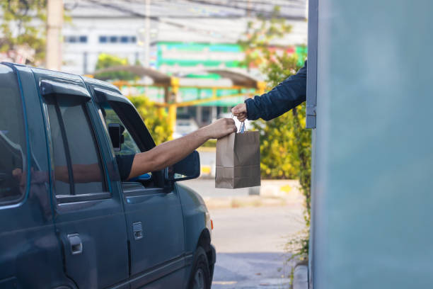 Hand Man in car receiving food in drive thru fast food restaurant. Hand Man in car receiving food in drive thru fast food restaurant. drive through photos stock pictures, royalty-free photos & images