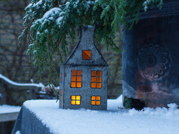 istock winter snowy garden with a decorative backlit house,  selective focus image 1354904758