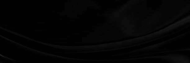 istock Black gray satin dark fabric texture luxurious shiny that is abstract silk cloth panorama background with patterns soft waves blur beautiful. 1354904775