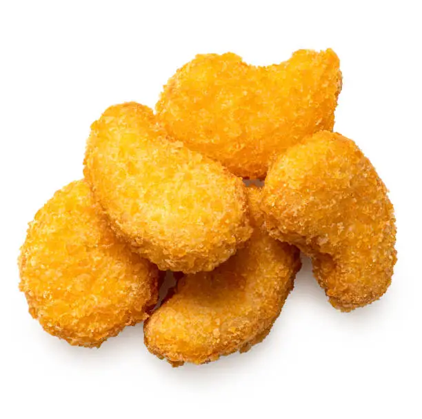 Pile of fried gluten free cornflake crumb chicken nuggets isolated on white. Top view.
