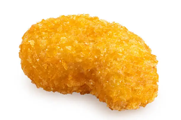 Fried gluten free cornflake crumb chicken nugget isolated on white.