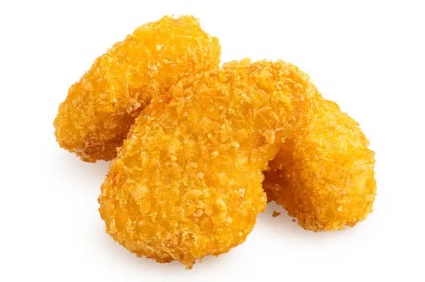Three fried gluten free corn flake crumb chicken nuggets isolated on white.