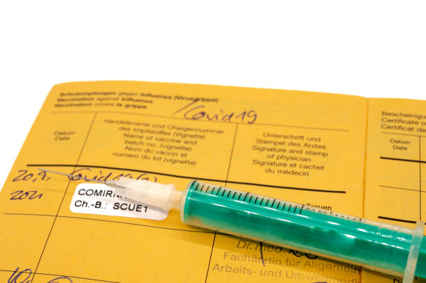istock Vaccination book with syringe and Covid vaccination in german 1354905968