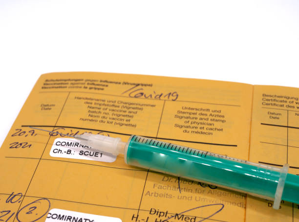 istock Vaccination book with syringe and Covid vaccination in german 1354905975