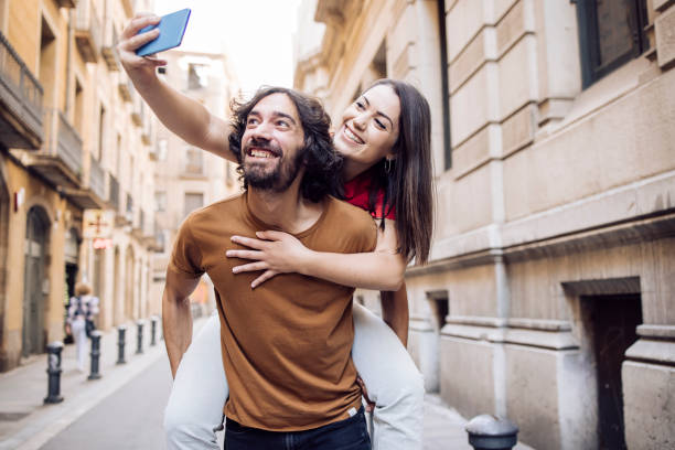 istock Couple taking a selfie and having fun on their vacation 1354906759