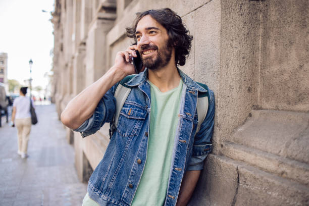 istock Young tourist telephoning while walking through Barcelona 1354906843