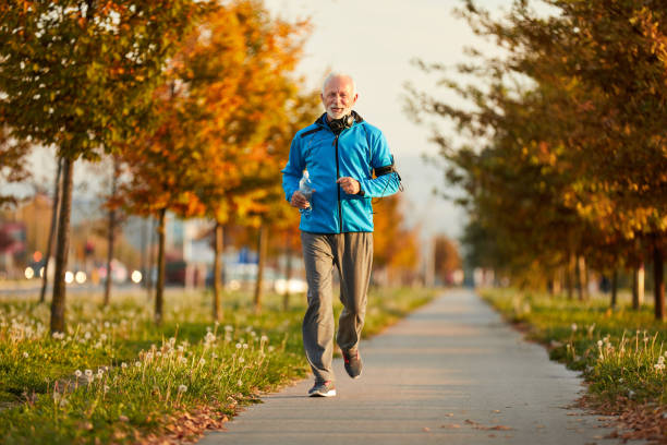 istock Active senior male jogging outdoors 1354907093