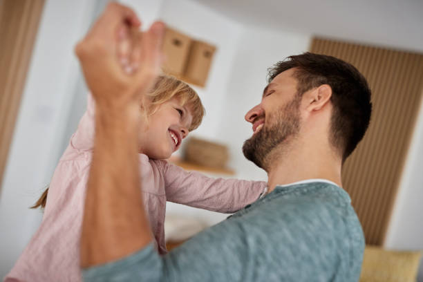 istock Father playing with a little daughter at home 1354907196