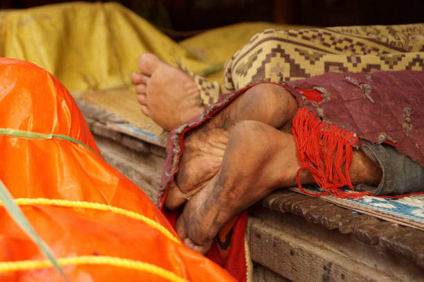 istock Men resting in market after hard work. Hard working feet covered with cloth 1354909892