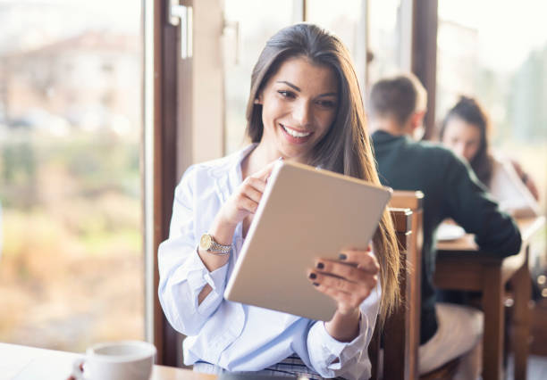 istock Portrait Of A Smiling Woman Using A Digital Tablet 1354910032
