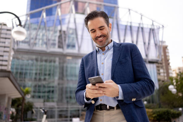istock Successful businessman of Hispanic ethnicity using a smart phone 1354910715