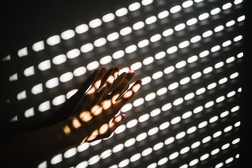 Female hand in harsh light with dark shadows