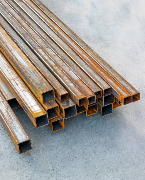 Pile of structural steel square tubes on the ground Pile of rusty structural steel square tubes on the ground structural steel stock pictures, royalty-free photos & images