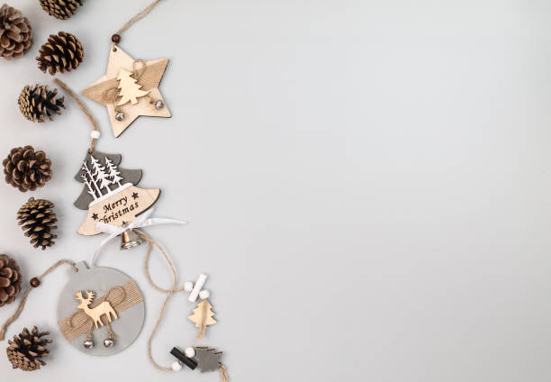 istock Wooden Christmas decorations and pine cones on gray background, top view, copy space 1354912504