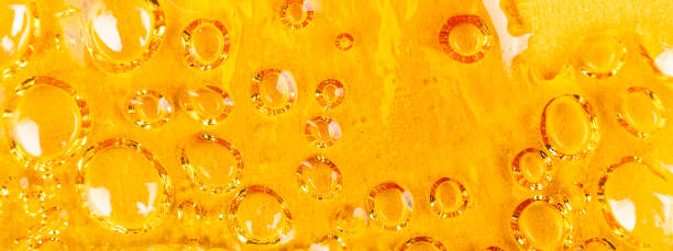 strong extract of gold cannabis wax with high thc close up stock photo