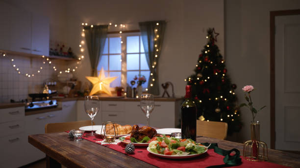 istock romantic table setting dinner for two in a decorated home interior with christmas tree and led lights 1354915004