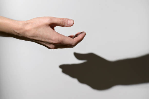 istock Conceptual Help with Hand and Other Hand Shadow 1354915398