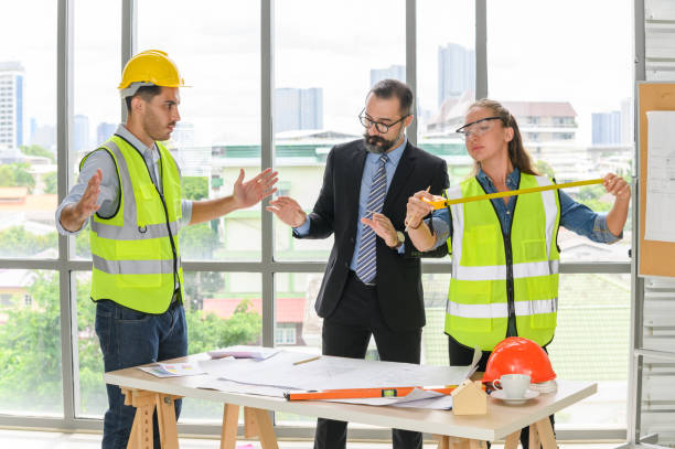 istock Engineers team meeting for architectural project. architects discussing blueprint with construction manager in office worker conference site. Construction Concept 1354915649