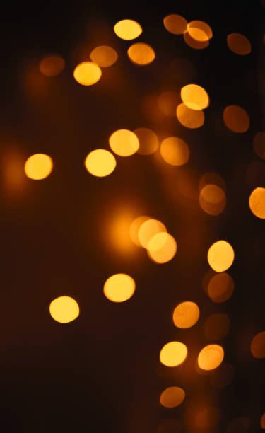 istock Christmas dark  glowing Golden Abstract Background. Blurred Xmas Bokeh lights 1354917607