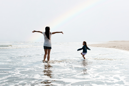 Mother and daughter playing on the rainbow beach