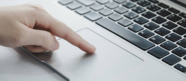 istock Authentication. close up hand touching touchpad on laptop computer at office, work from home, searching web, social network, online, business strategy, finance, investment, digital technology concept 1354919395
