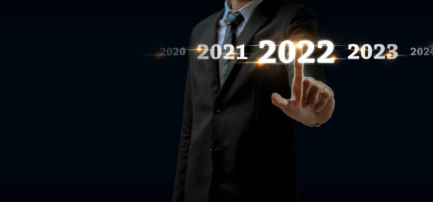 istock 2022. businessman hand touching and pointing on year 2022 with virtual screen on dark background, goal target, change from 2021 to 2022, strategy, investment, business planning, happy new year concept 1354919397