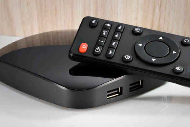 istock Three quarter view of black modern smart tv converter set, isolated 1354922425