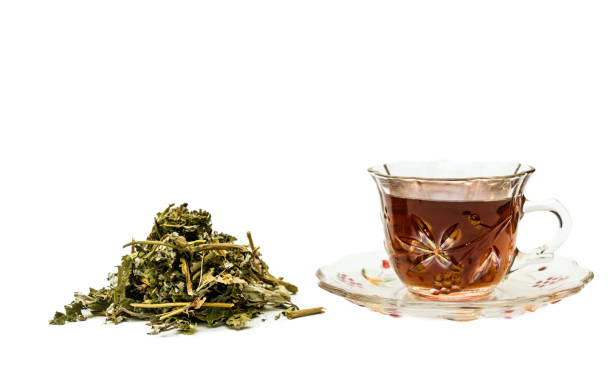 istock Cup of herbal healing tea on a white background 1354923583