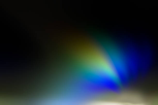 Curved colored rays blue, green, orange on a dark background.