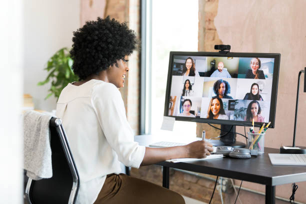 istock Female CEO takes notes during virtual meeting with diverse employees 1354923998