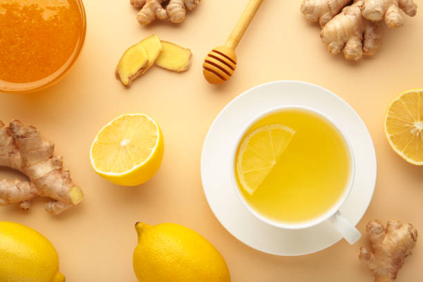 istock Ginger tea with lemon in a white cup on beige background. 1354925061