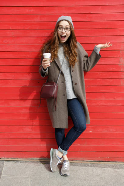 istock Woman drinking take away coffee and holding copyspace on palm 1354927601
